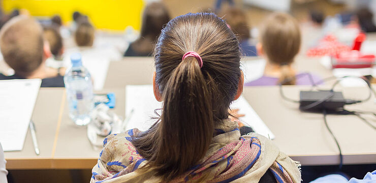 Viele junge Menschen sitzen in einem Hörsaal