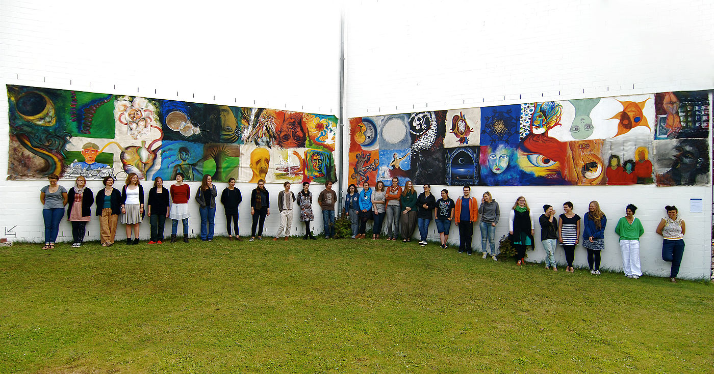 Studierende mit ihren großformatigen Kunstwerken vor dem Hochschulgebäude der HKS Ottersberg 